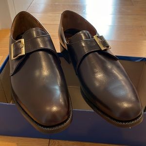 A new pair of Church’s of England dark brown, single monk strap dress shoes.